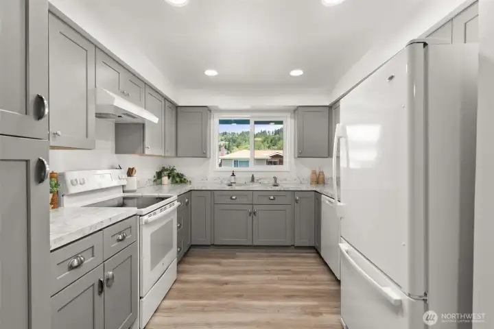 Updated Kitchen, New cabinets, paint, flooring, and countertops.