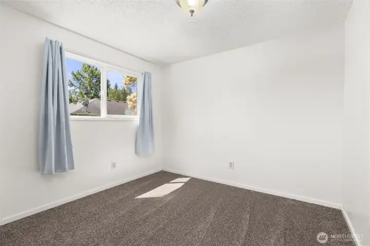 Bedroom 2 with new paint, new trim and new carpet.