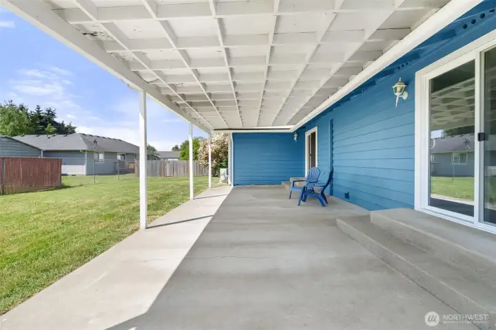 Covered patio with 2 sliding door entrances.