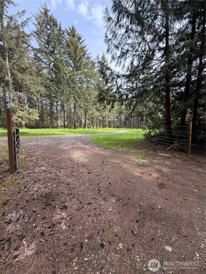 Wide gated entrance off a private drive.