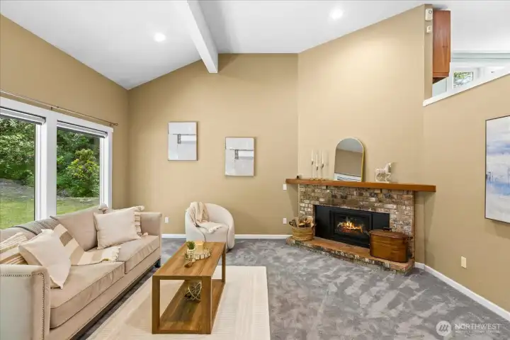 Airy living room off the entry with a gas fireplace.