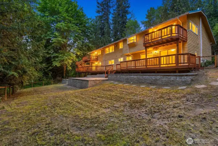 Back of the house from the corner of the fenced backyard. Large paver patio!