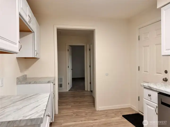 Kitchen viewing the Back Door and Hallway to Laundry Room, 2nd 3/4 Bathroom, and Bedrooms 2 & 3