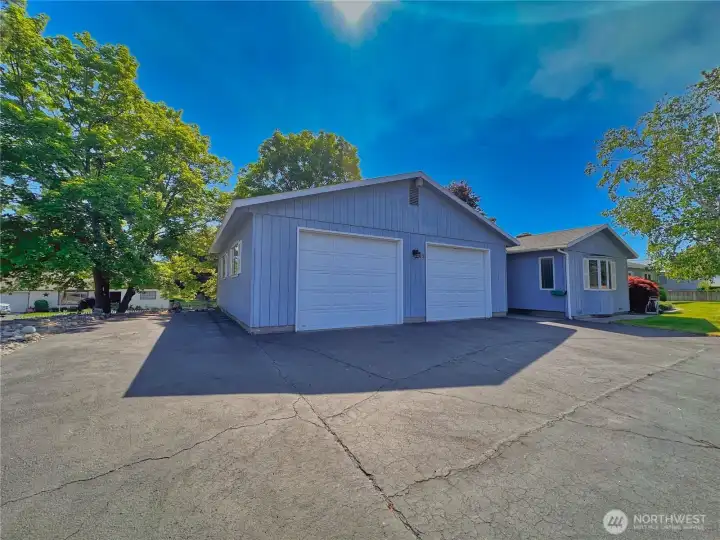 A spacious 30x30 detached garage provides ample room for vehicles, storage, hobbies, or workshop space. There's even paved side parking for your RV/trailer too.