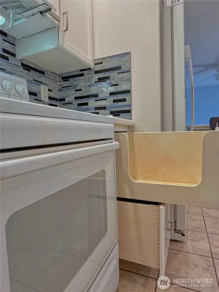 Custom cabinets with deep, functional drawers designed for effortless storage of cookware and appliances.