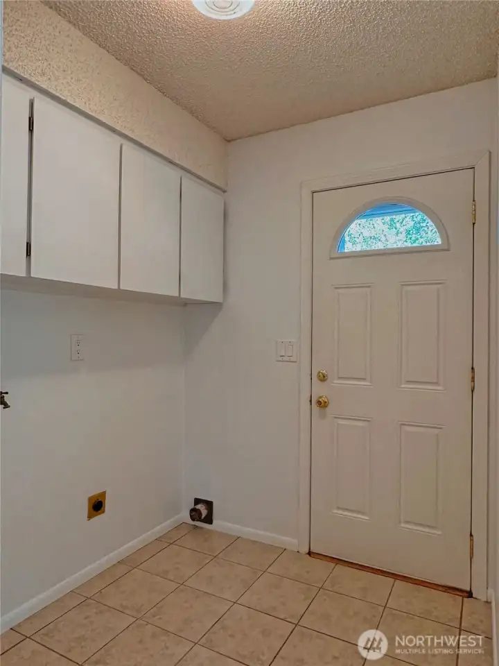 The laundry room is next to the kitchen making it easy to multitask.