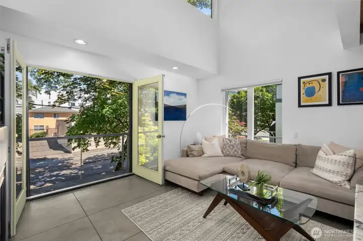 French doors open the living space to the outdoors, creating a seamless indoor-outdoor connection and filling the home with natural light. French doors open the living space to the outdoors, creating a seamless indoor-outdoor connection and filling the home with natural light.