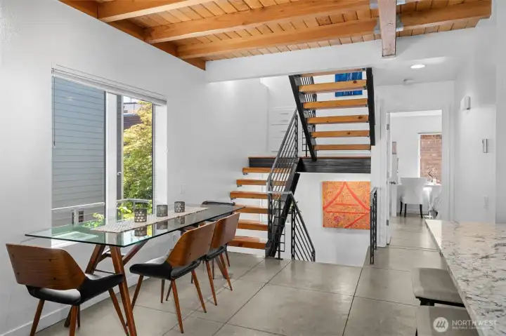 Inviting dining space anchored by dramatic ceilings and abundant natural light. Inviting dining space anchored by dramatic ceilings and abundant natural light.