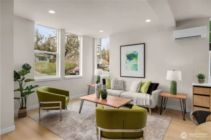 Bright, open-concept main level flooded with natural light from expansive windows. (photos are of model home, same community similar finishes)
