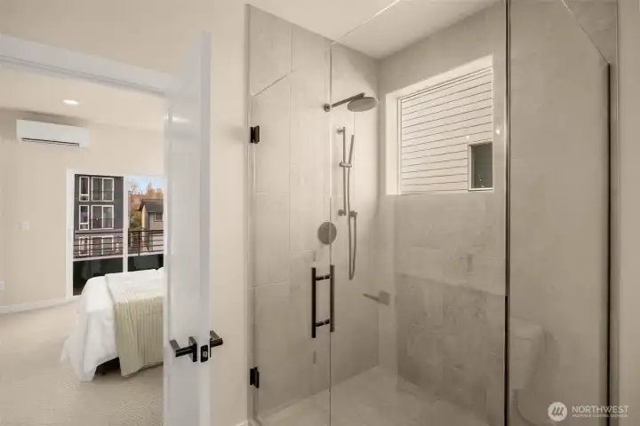 Sleek modern bathroom showcasing elegant tile work and high-end plumbing fixtures. (photos are of model home, same community similar finishes)