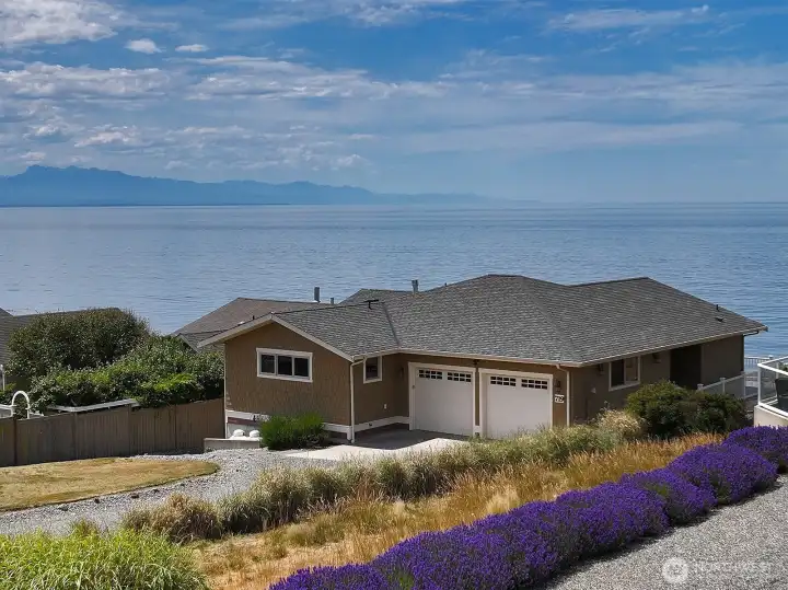 A home by the sea. The two car garage is a great bonus. The main entrance is on the right side of this photo. A home by the sea. The two car garage is a great bonus. The main entrance is on the right side of this photo.
