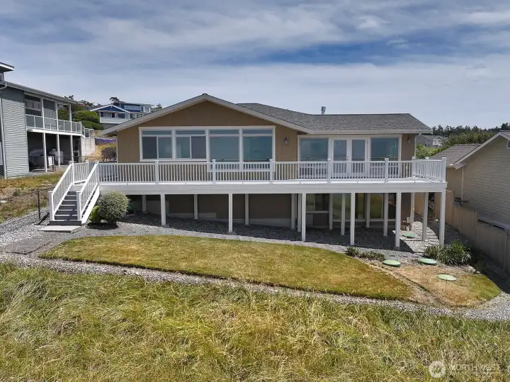 The water is to the photographer's back in this photo. Here we see the deck perfect for sunsets. The french doors to the right of the photo lead into the living room. Another perspective of the daylight basement on the lower level. The water is to the photographer's back in this photo. Here we see the deck perfect for sunsets. The french doors to the right of the photo lead into the living room. Another perspective of the daylight basement on the lower level.