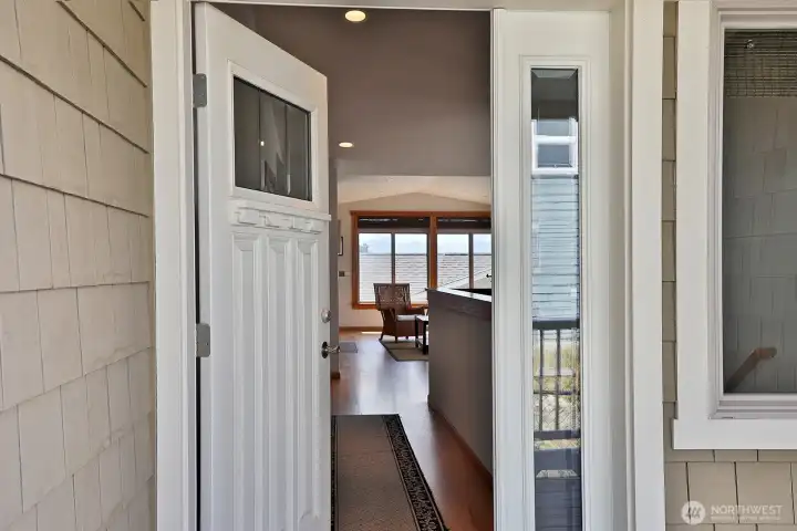 Here we are entering through the main door. To the right of this photo are the stairs that lead to the lower level. Straight ahead is the living room. We turn left down the hall for the primary bedroom and bath. Here we are entering through the main door. To the right of this photo are the stairs that lead to the lower level. Straight ahead is the living room. We turn left down the hall for the primary bedroom and bath.