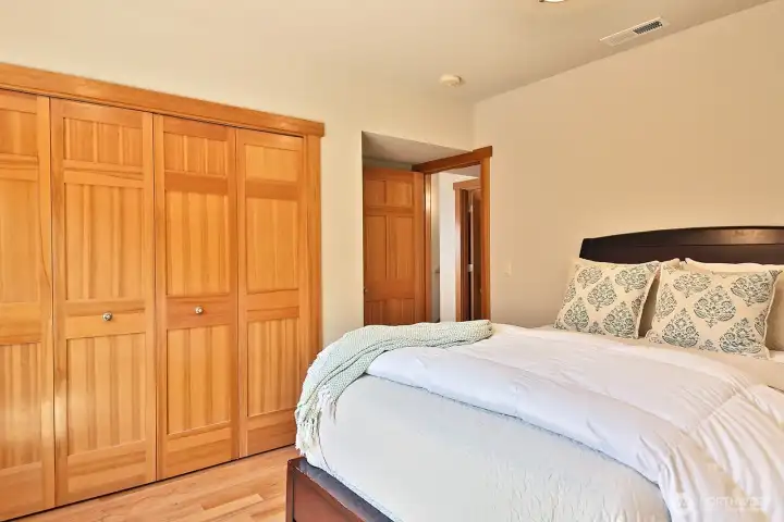Lower level bedroom with a large closet with built-in shelving. Lower level bedroom with a large closet with built-in shelving.