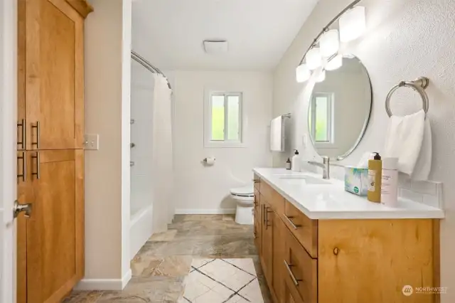 This main floor bathroom includes a built-in linen cabinet and a bidet commode. Very nice!