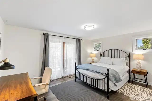 Primary bedroom with french doors that lead out to the deck