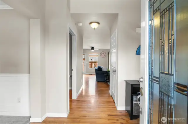 Soaring entry with ceiling fan and real hardwood floors.