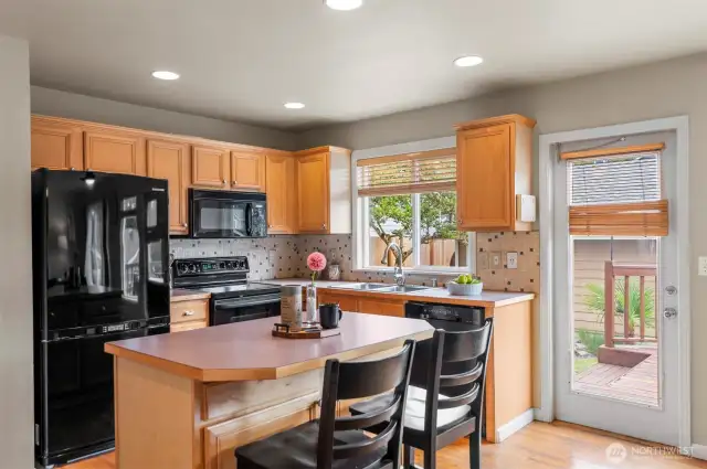 Kitchen with eating space overlook private backyard, and oversized deck