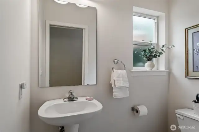 Main Floor Half Bath offers natural light from window.