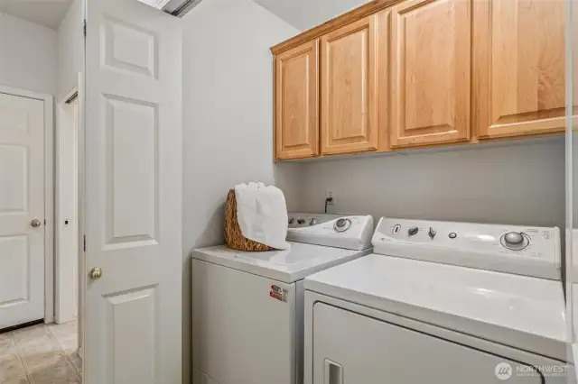 Nice Laundry area with cabinets for storage.