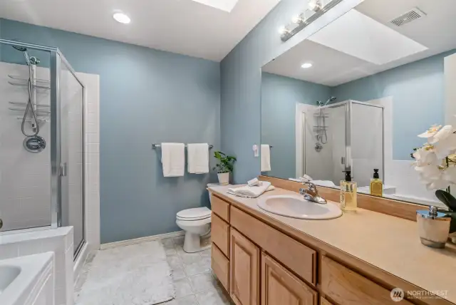 Primary bathroom is spacious and has skylight for really great lighting.