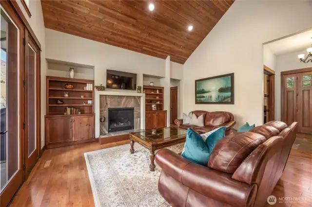 Living room with propane fireplace and cherry cabinet built-ins