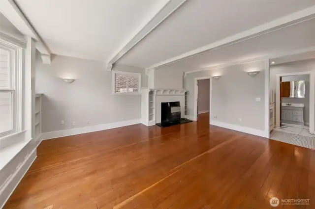 Apartment #1 - Offering an expansive entry and living area with natural light from six craftsmen style windows, built in bookshelves, box beam ceiling and 124-year-old fir floors, apartment number 1 was the original living room of this grand residence. Located on the first floor, it features a fireplace, a free standing gas furnace, one bedroom with large closet, kitchen with new stove, 3/4 bathroom and new paint throughout.