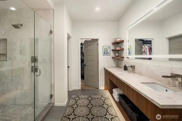 Another view of the primary bath with a walk-in closet.