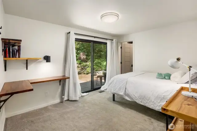 Additional bedroom with ensuite bath and slider to the outdoors.