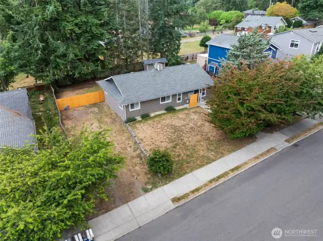 Nice lot with beautiful trees and a fully fenced back yard and space to put a carport or build a garage