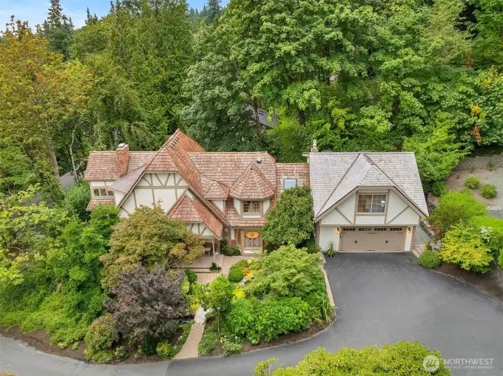 Storybook Tudor curb appeal—nestled in lush gardens with timeless architecture and a brand-new attached/integrated ADU above the garage