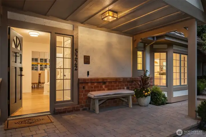 Inviting front porch with brick accents and a warm, welcoming glow.