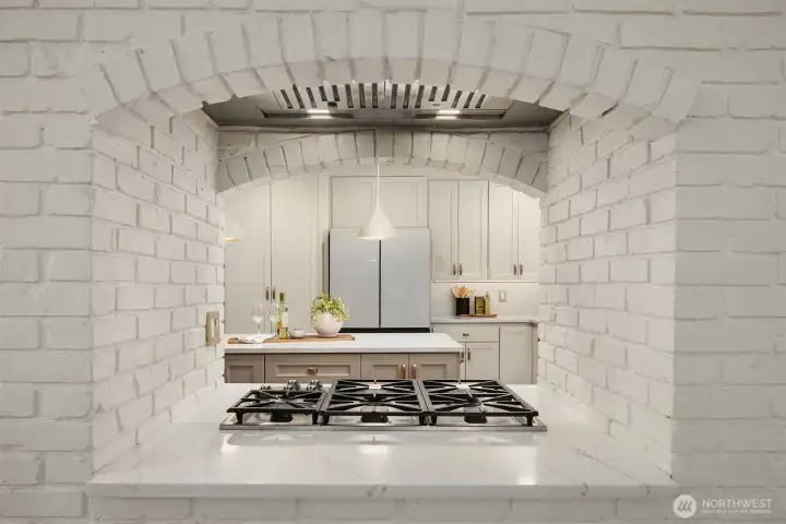 Charming brick arch detail frames the cooktop with character and style