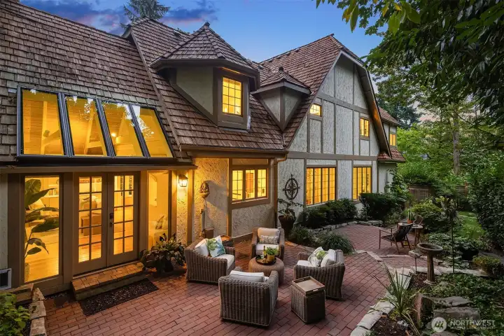 French doors open to a spacious brick patio for outdoor entertaining