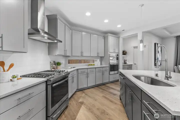 High-end stainless appliances, range hood, and ample counter space in this chef-inspired Enumclaw kitchen.