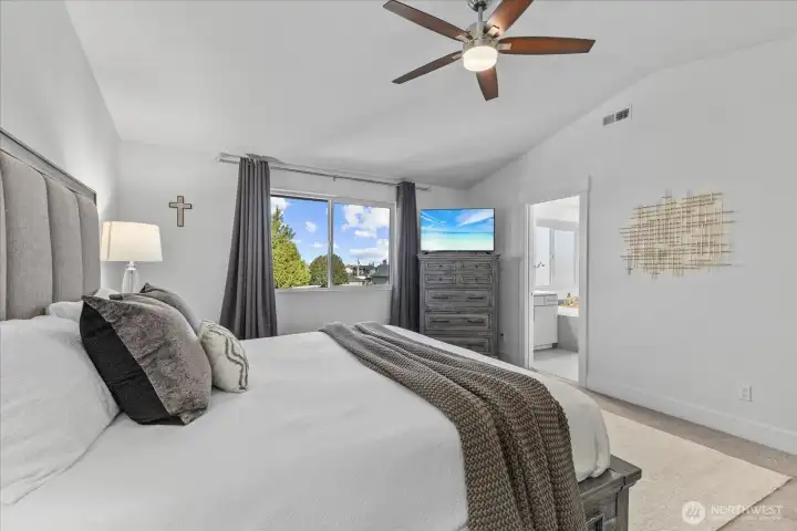 Private primary retreat offering generous square footage, natural light, and space for seating or workspace.