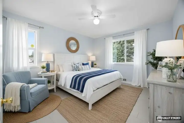 Virtually Staged guest bedroom with new flooring, paint, and light fixture.