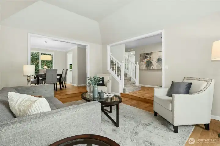 Angle looking back towards the formal dining room showing the tall and elegant coved ceiling. Note the extended hardwoods in both the living and dining areas.