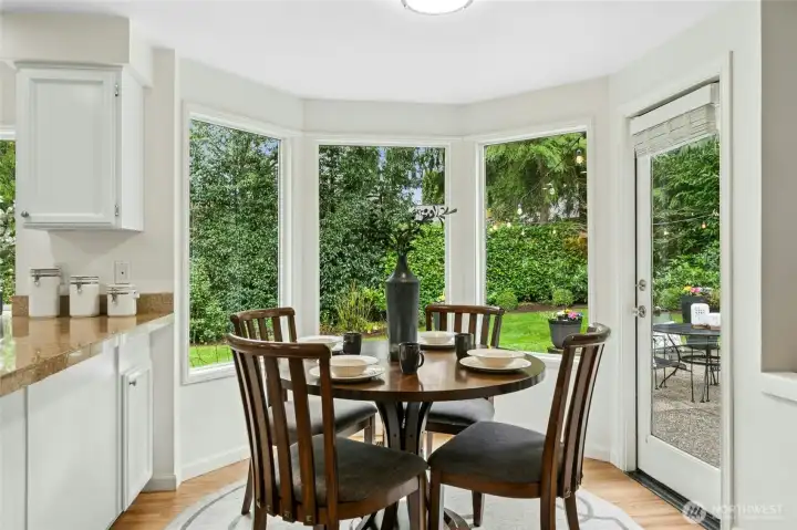 Beautiful informal breakfast nook area with a French door leading out to the backyard space.
