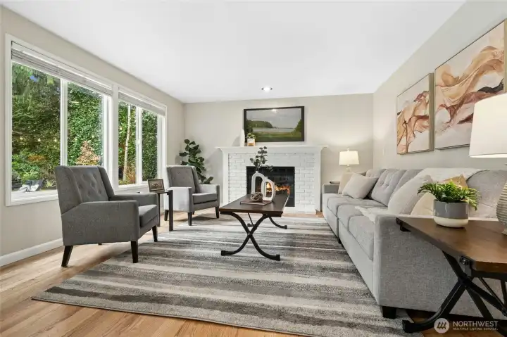 Family room with a wall of light flooding windows.