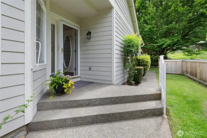 Entrance on west side of home with professionally maintained landscaping included in the HOA