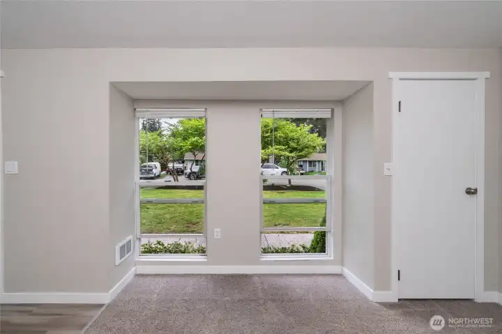 Windows in the main area of the living room. The door on the right is for storage.