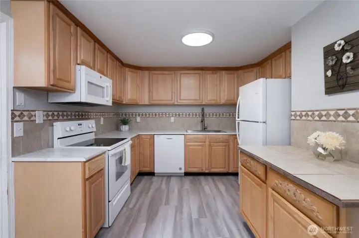 Lots of counter space and oak cabinets. Room for a prep station or coffee bar!
