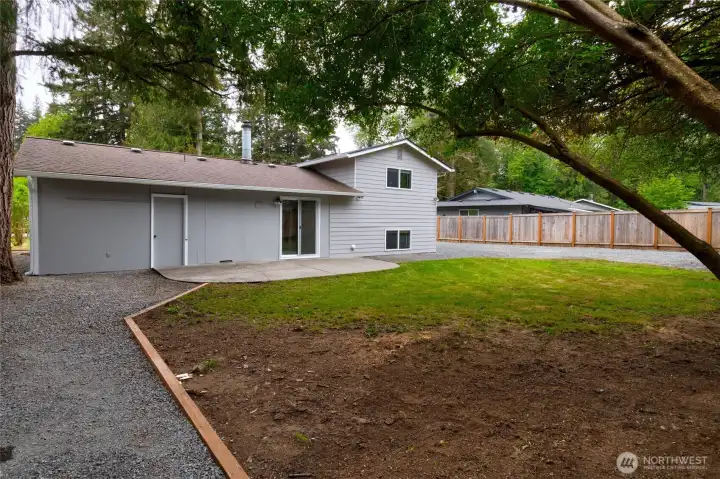 Large back yard! Door left of the slider is to a nice storage room for toys, bikes, extra pantry items or maybe a craft room! So much parking!