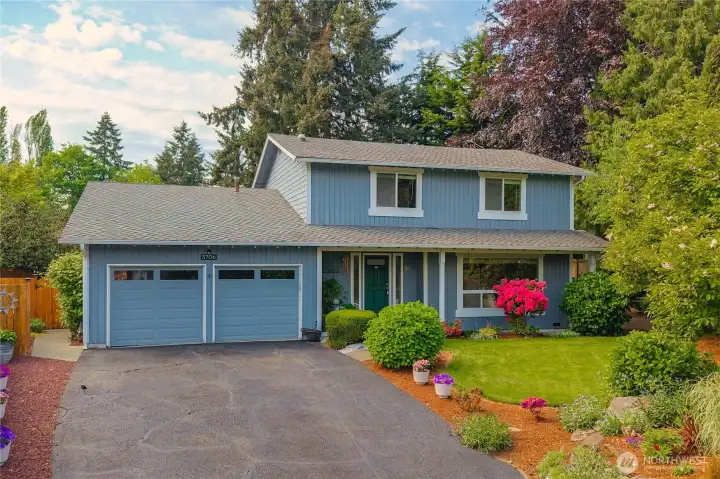 Large covered front porch, beautiful gardens and mature landscaping