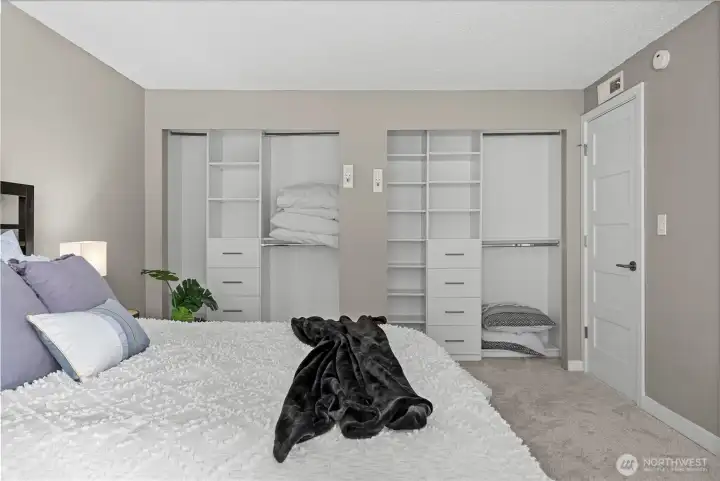 Primary suite offers dual closets with built in shelving