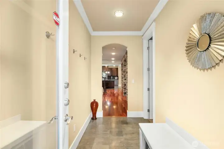 From the mudroom view, the den is on the right and the door on the left leads to the three-car garage.