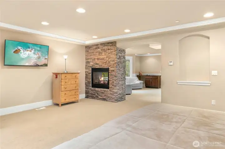 uxurious primary suite highlighted by an elegant fireplace.