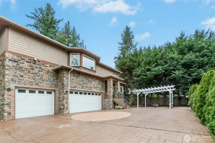 Beautifully designed driveway highlighted by impressive custom stonework.
