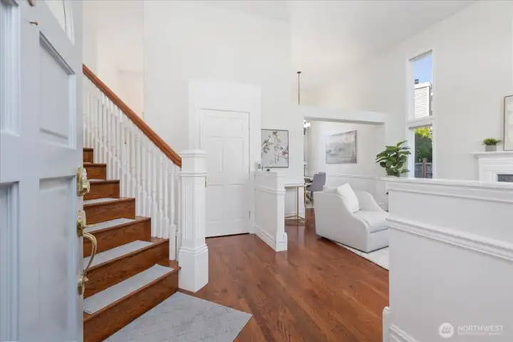 Hardwood flooring and tall ceilings upon entry